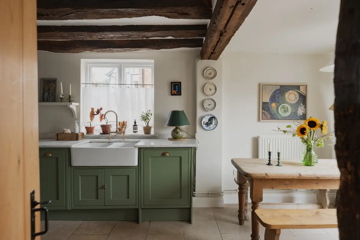 A Charming English Cottage with a Sage-Green Kitchen 6 sage green cottage kitchen butler sink exposed beams
