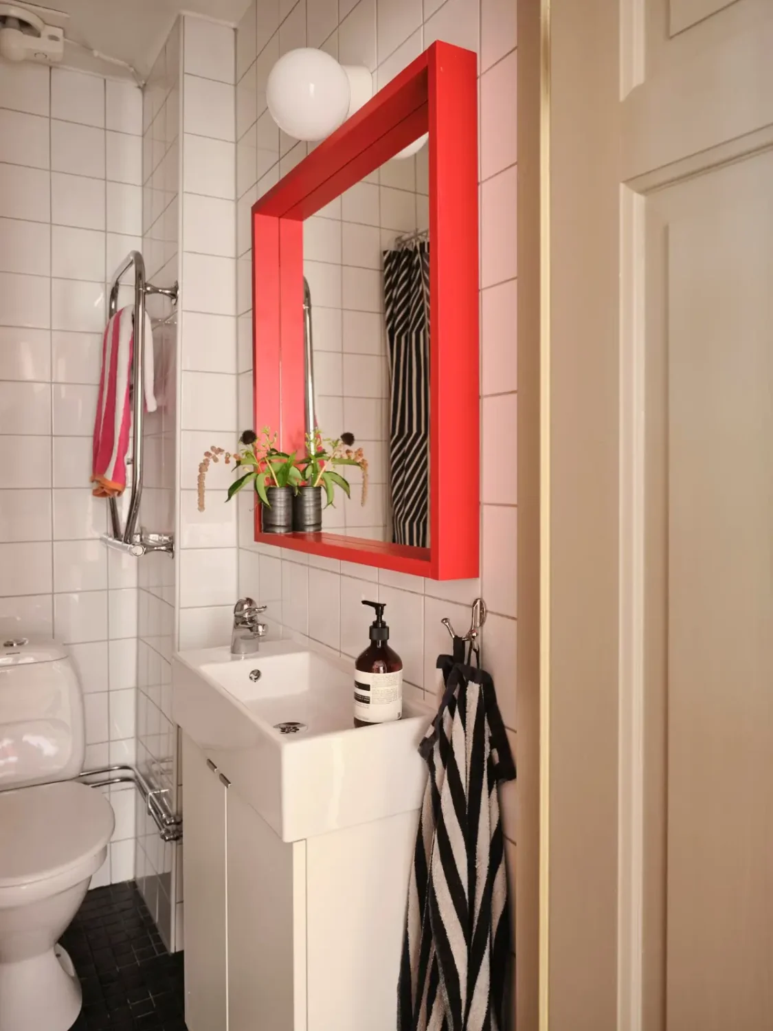 Color, Books, and a Walk-In Wardrobe in a Small Stockholm Apartment 27 small bathroom red framed mirror
