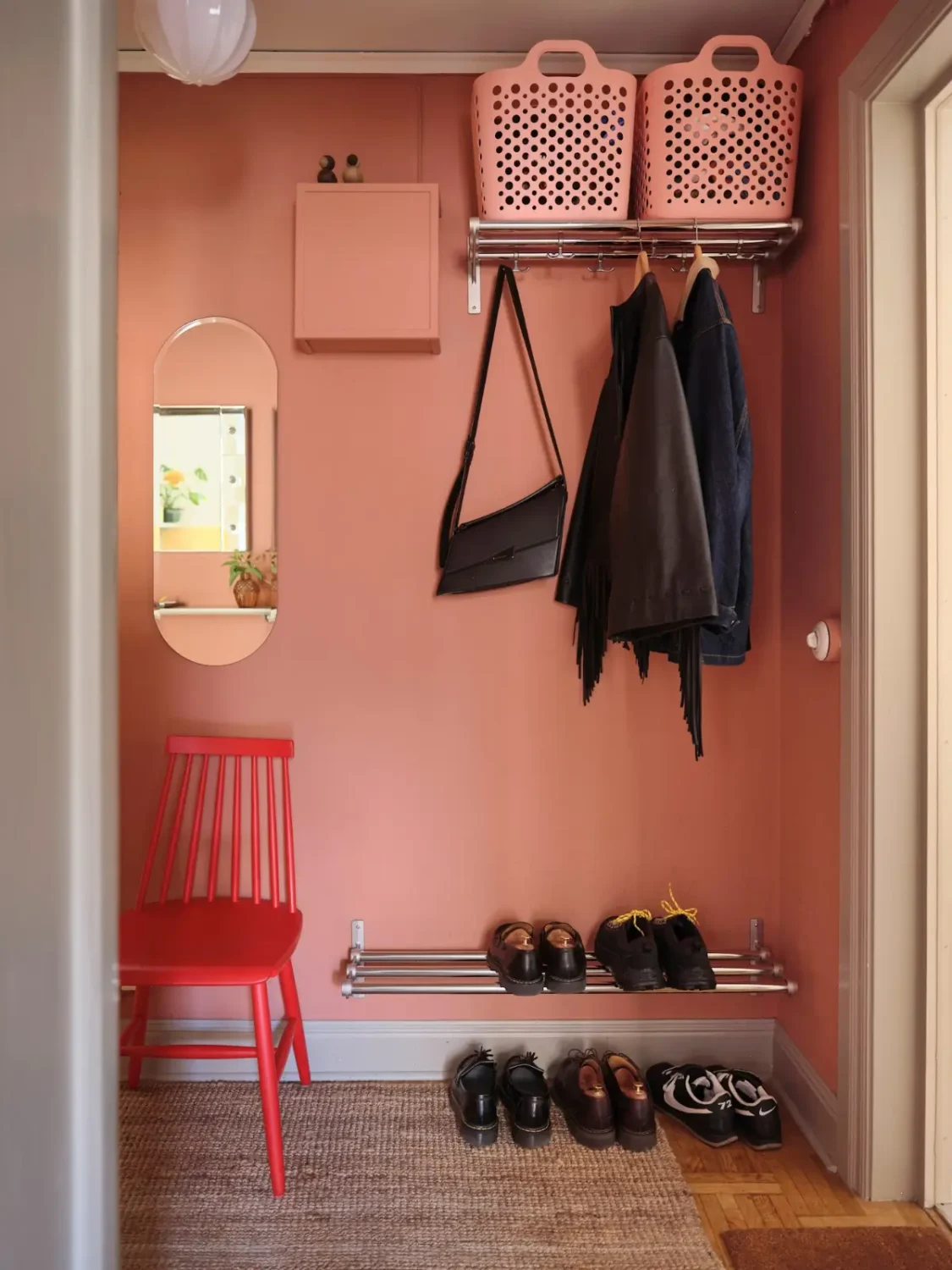 Color, Books, and a Walk-In Wardrobe in a Small Stockholm Apartment 29 small pink hall simple shoes and coats hangers Color, Books, and a Walk-In Wardrobe in a Small Stockholm Apartment