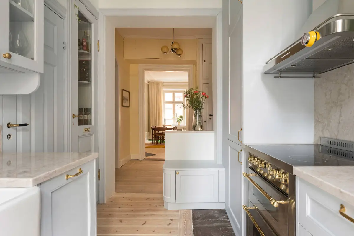 A Stylish Beige Apartment with a Light Blue Kitchen 9 small semi-open kitchen light blue cabinetsbrass fittings