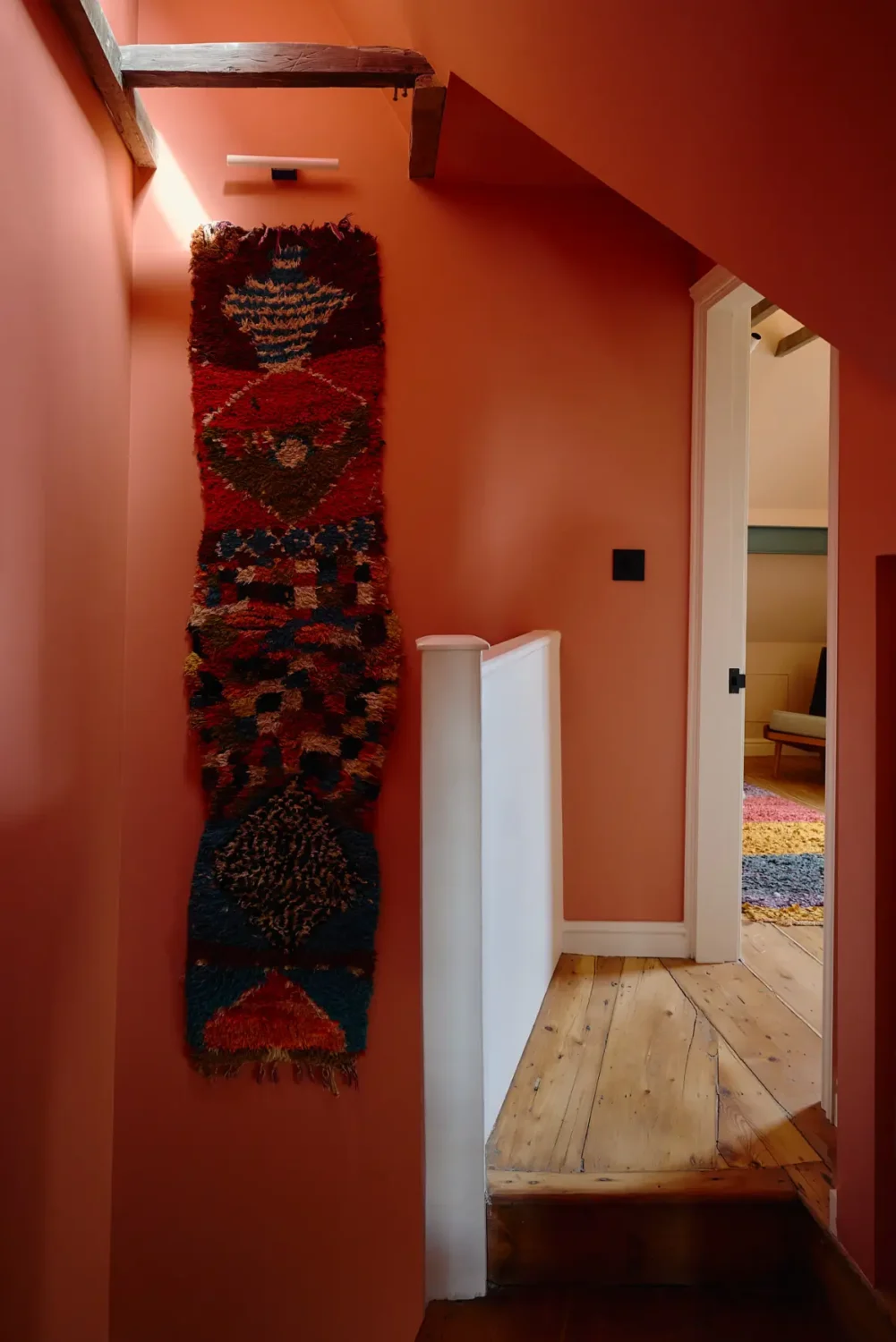 The Top Home Design Trends for 2026: Bold Color, Cozy Corners & Climate-Ready Living 4 terracotta red color drenched staircase The Top Home Design Trends for 2026: Bold Color, Cozy Corners & Climate-Ready Living