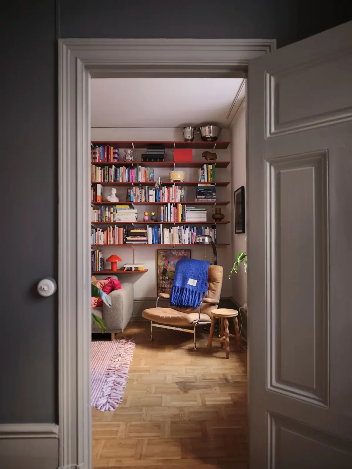Color, Books, and a Walk-In Wardrobe in a Small Stockholm Apartment 24 view into living room bookshelves