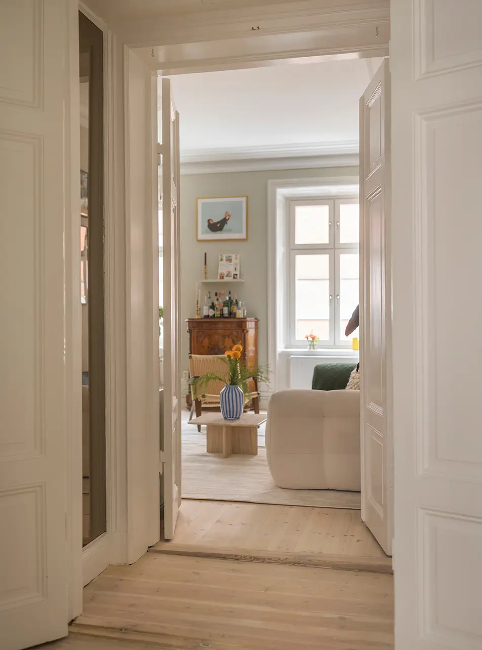 A Stylish Beige Apartment with a Light Blue Kitchen 8 view into living room