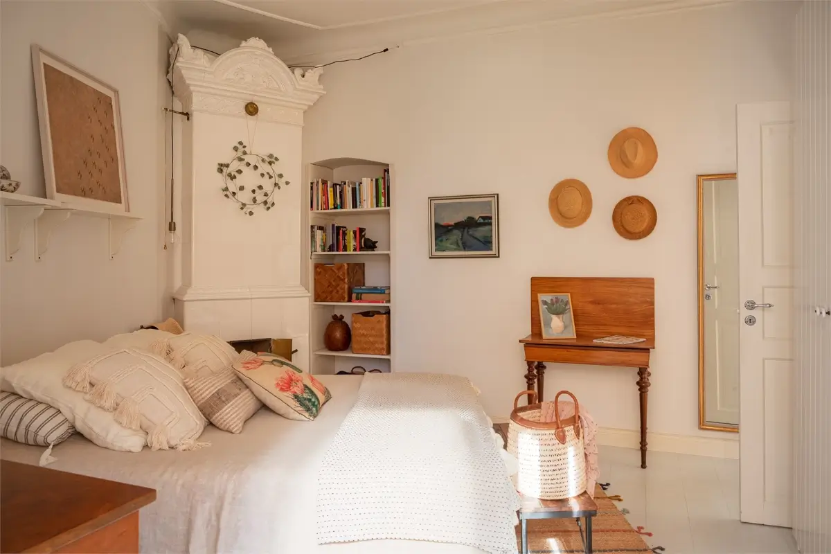 A Light-Filled Stockholm Apartment with a Charming Kitchen 21 white bedroom fireplace built-in bookshelves