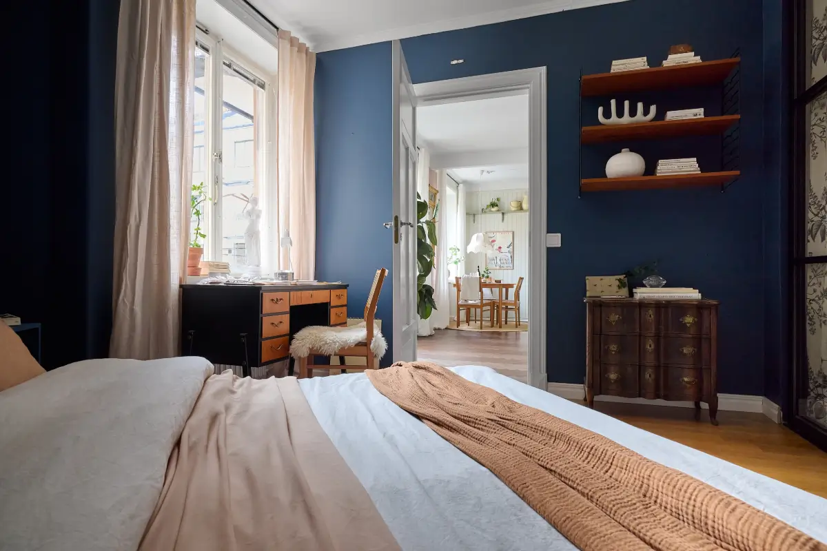 A Bright and Colorful 1930s Apartment in Stockholm 17 dark blue bedroom with desk