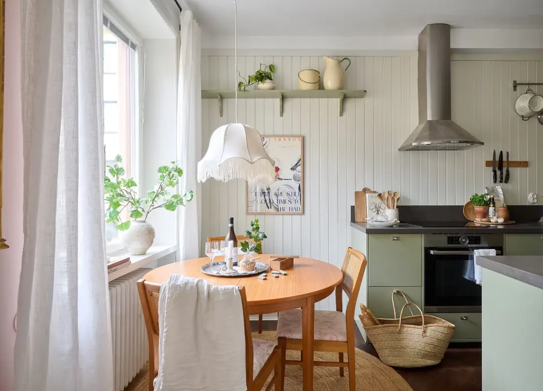 A Bright and Colorful 1930s Apartment in Stockholm 9 green kitchen round table paneled walls