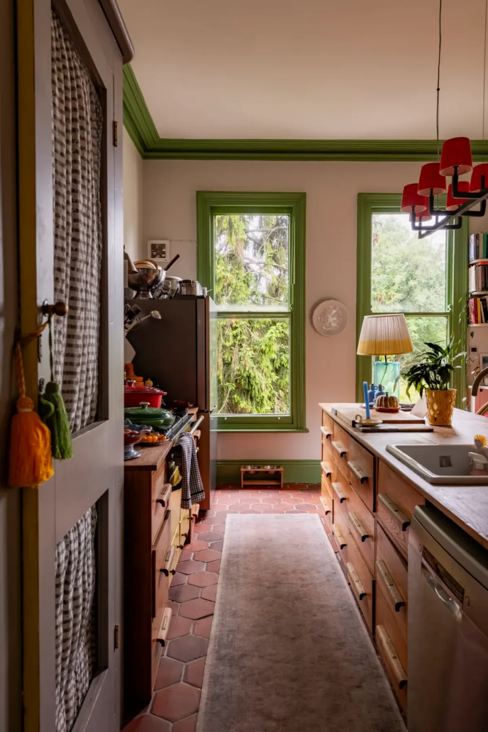 Trend Alert: The 'Soft Kitchen' is 2026's Coziest Interior Trend and It's Here to Stay 20 wooden kitchen terracotta floor green window frames best of 2025 kitchens nordroom Trend Alert: The 'Soft Kitchen' is 2026's Coziest Interior Trend and It's Here to Stay