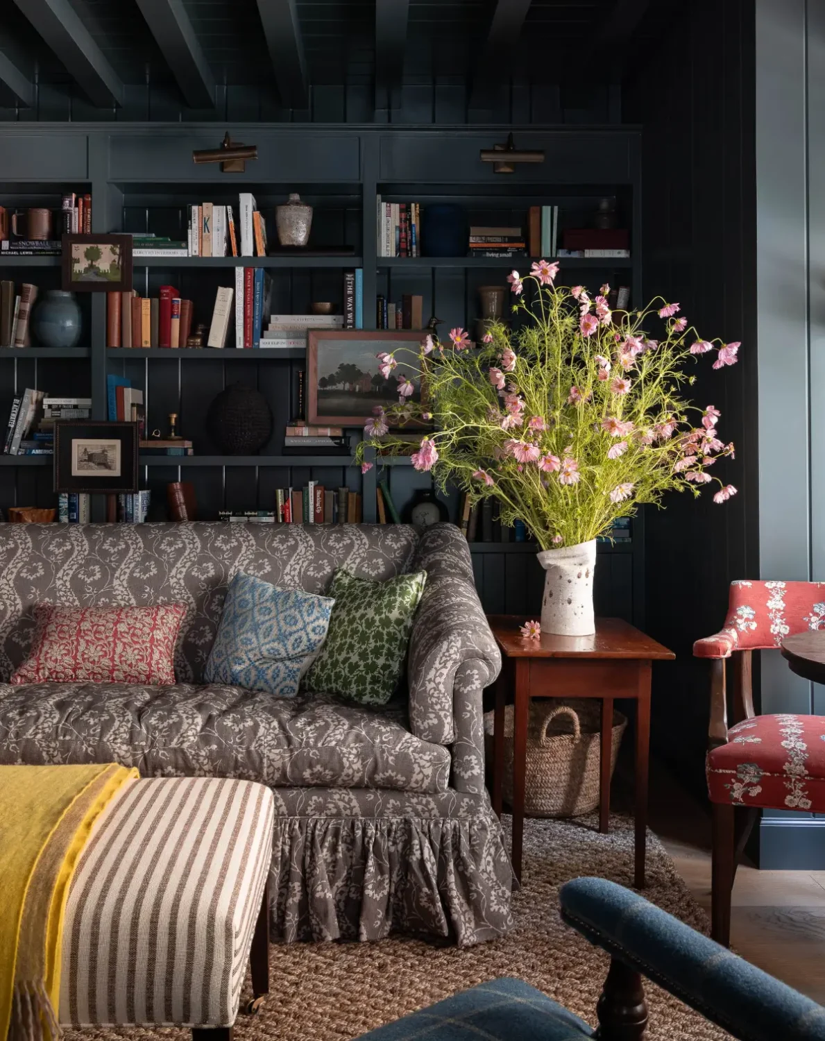 The 2026 Home Decor and Color Trends, According to Pinterest 2 cozy-dark-blue-sitting-room-layered-textiles-art-books