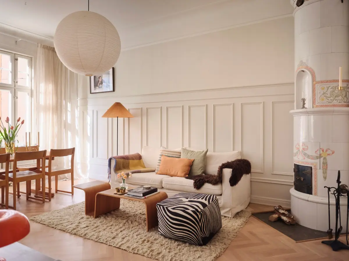 A Decorative Fireplace and Classic Touches in a 592 sq ft Stockholm Apartment 1 large-windows-period-features-renovated-early-20th-century-apartment-nordroom