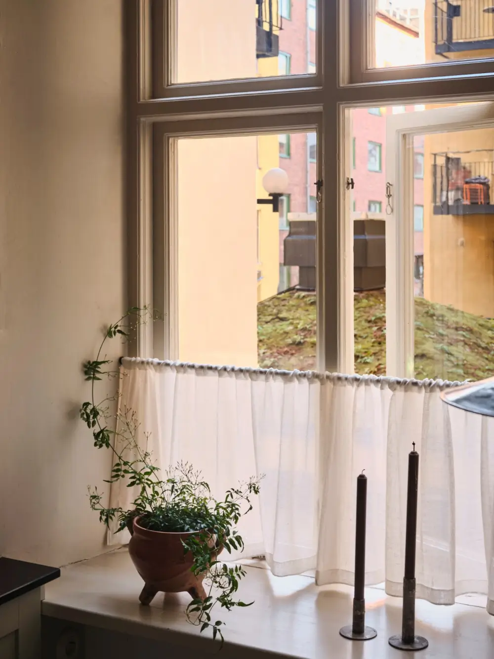 A Decorative Fireplace and Classic Touches in a 592 sq ft Stockholm Apartment 18 large-windows-period-features-renovated-early-20th-century-apartment-nordroom