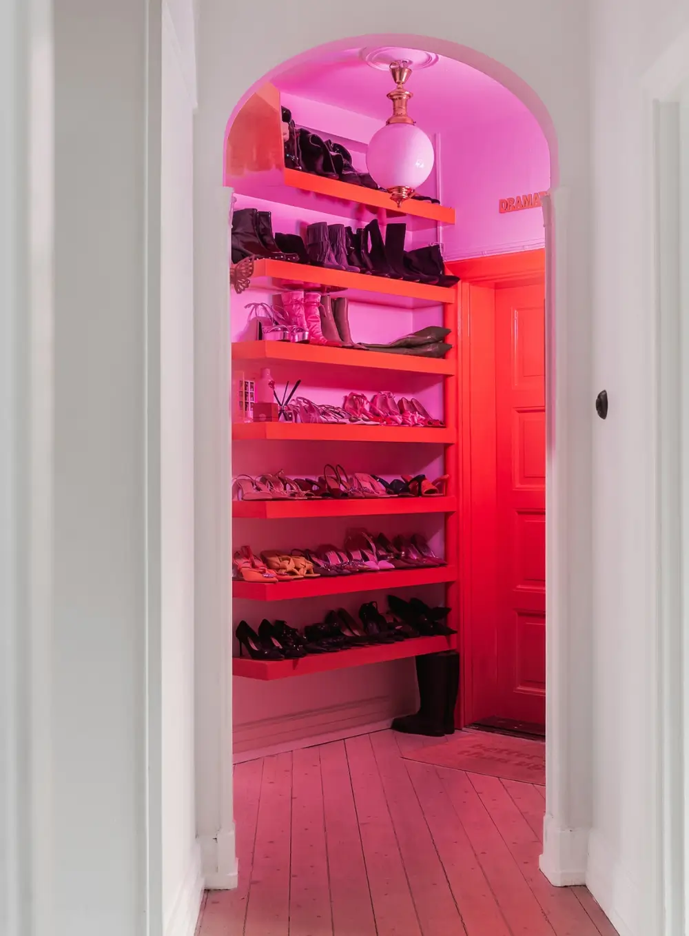 Whimsical Decor and Vibrant Color Accents in a Malmö Apartment 17 barbie-pink-hall-shelves-shoe-storage-nordroom