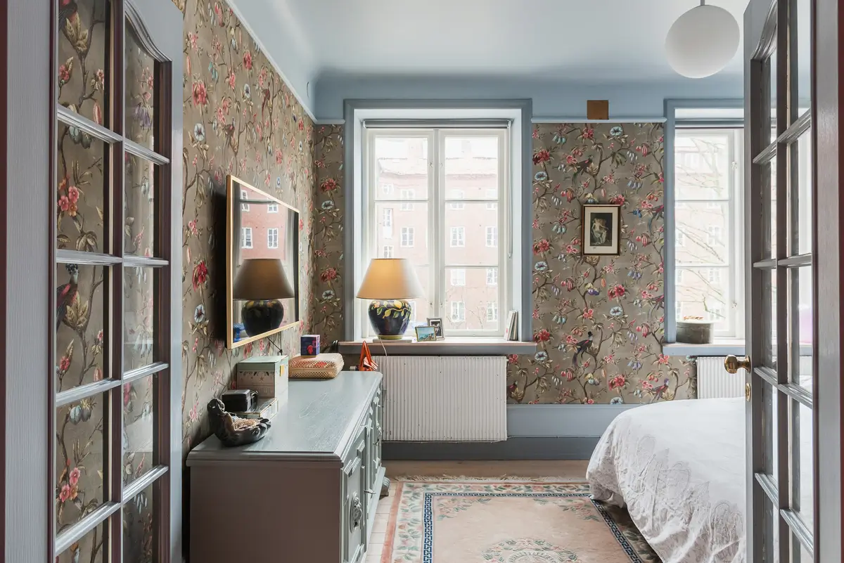 Whimsical Decor and Vibrant Color Accents in a Malmö Apartment 10 bedroom-floral-wallpaper-renovated-swedish-apartment-bold-colored-hall-nordroom