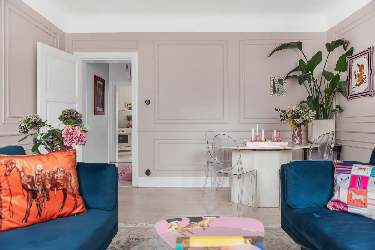 Whimsical Decor and Vibrant Color Accents in a Malmö Apartment 4 dusty-pink-living-room-renovated-swedish-apartment-bold-colored-hall-nordroom