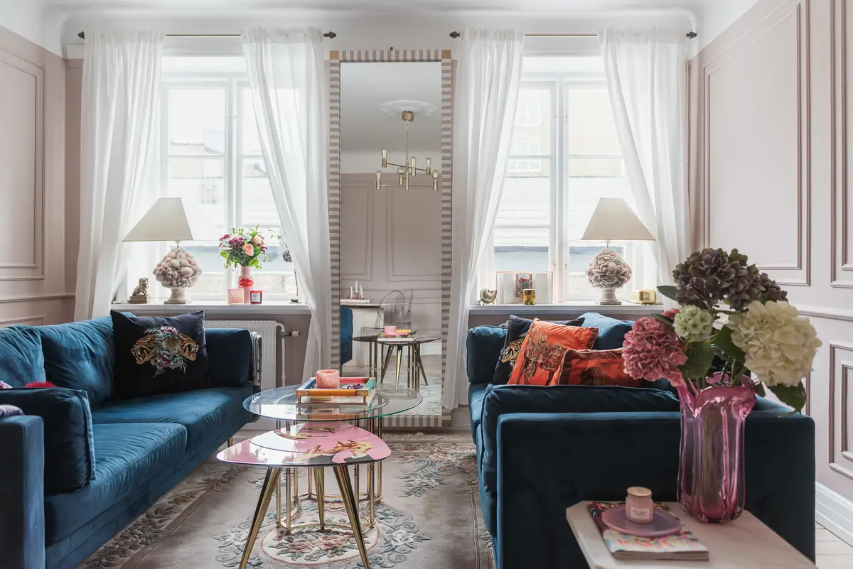 Whimsical Decor and Vibrant Color Accents in a Malmö Apartment 2 pink-living-room-large-windows-mirror-renovated-swedish-apartment-bold-colored-hall-nordroom