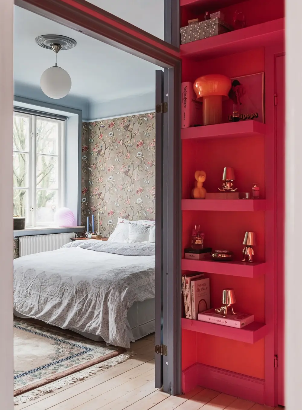 Whimsical Decor and Vibrant Color Accents in a Malmö Apartment 9 pink-orange-hall-view-into-bedroom-floral-wallpaper